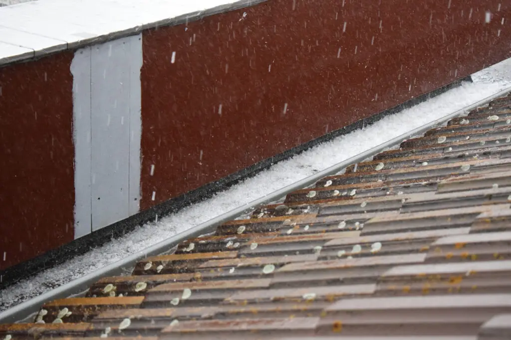 Metal roofing durability - A home's metal roof during a hail storm.