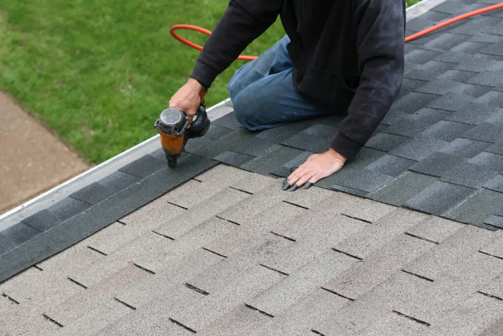 A homeowner doing DIY roof repair at his home.