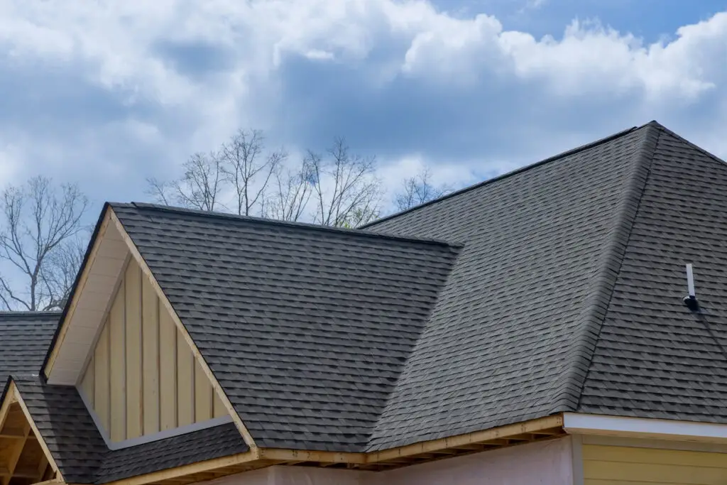 Roof replacement aftercare - A home's new roof made of asphalt shingles.