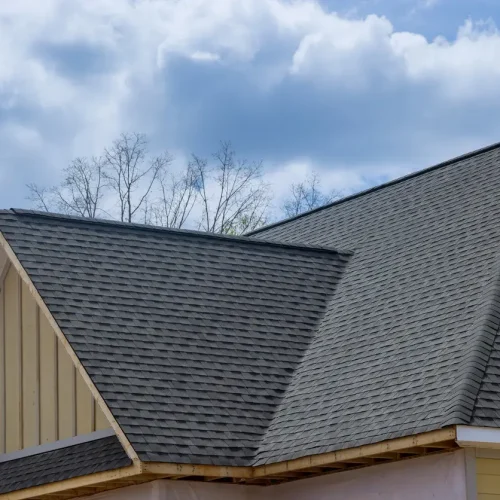 Roof replacement aftercare - A home's new roof made of asphalt shingles.