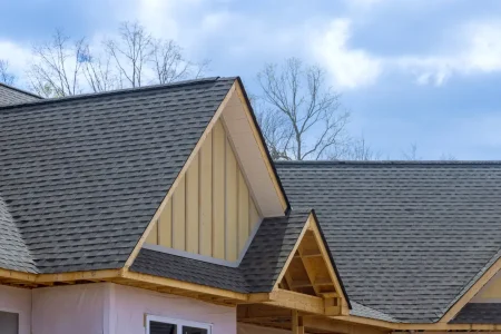 Newly constructed home with overlapping shingles on the roof.