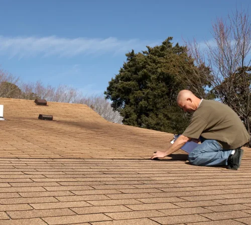 Roof inspection importance - A male contractor checking a home's roof quality.