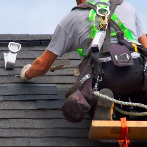 a roofer fixing shingles on a roof - Roofing fixing near Idaho Falls